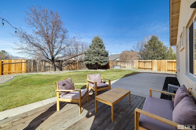 wooden deck with a yard, an outdoor living space, and a patio area