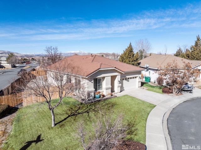 ranch-style home featuring a garage and a front lawn