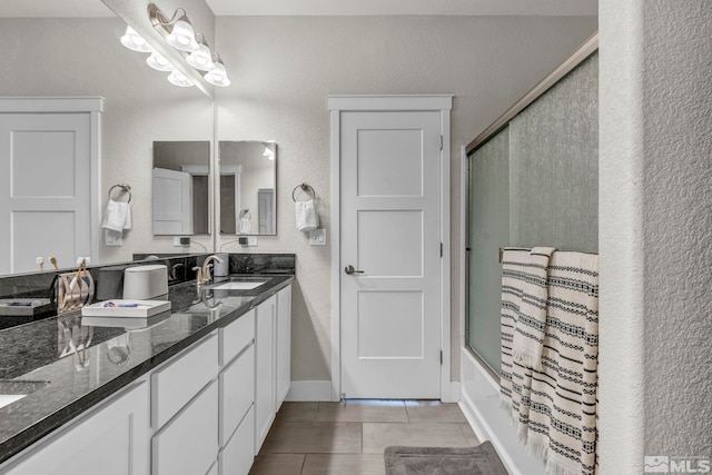 bathroom featuring vanity and bath / shower combo with glass door