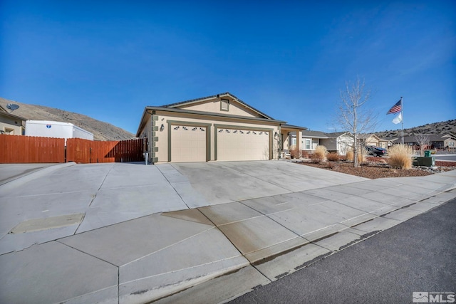 single story home featuring a garage and a mountain view