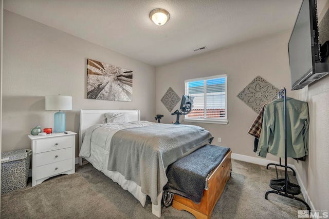 bedroom with carpet flooring and a textured ceiling