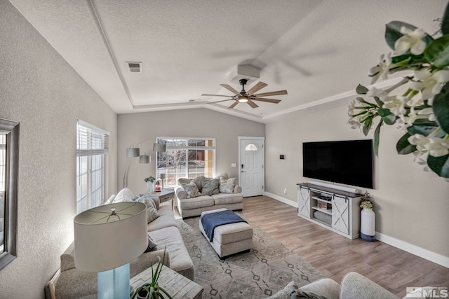 living room with ceiling fan, lofted ceiling, light hardwood / wood-style floors, and a textured ceiling