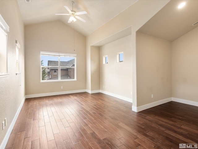 empty room featuring dark hardwood / wood-style flooring, lofted ceiling, and ceiling fan