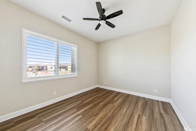 unfurnished room featuring dark hardwood / wood-style floors and ceiling fan