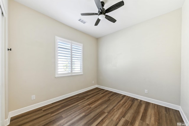 empty room featuring ceiling fan and dark hardwood / wood-style floors