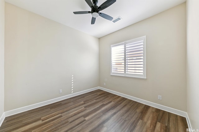 spare room featuring ceiling fan and dark hardwood / wood-style flooring