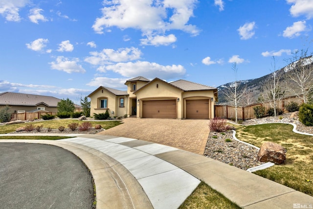 view of front of home with a mountain view and a garage