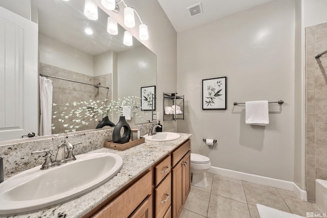 bathroom featuring vanity, tile patterned floors, and toilet