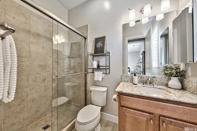 bathroom with walk in shower, vanity, and toilet