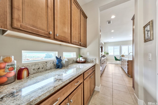 kitchen with light stone counters and light tile patterned flooring