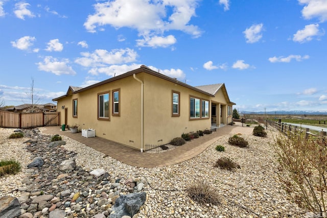 view of property exterior featuring a patio area