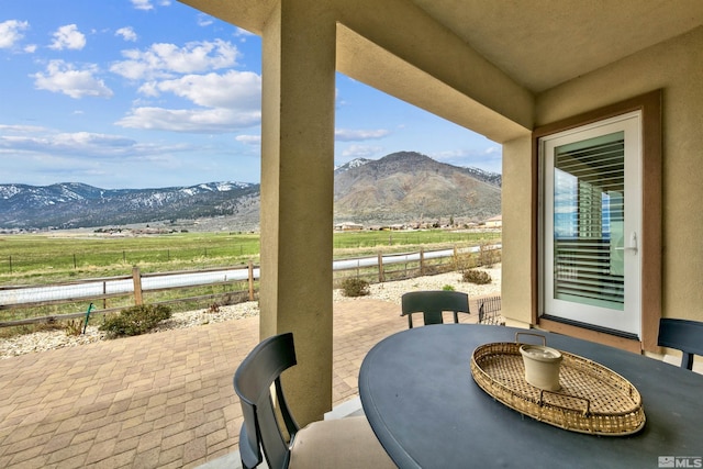 view of patio with a mountain view and a rural view