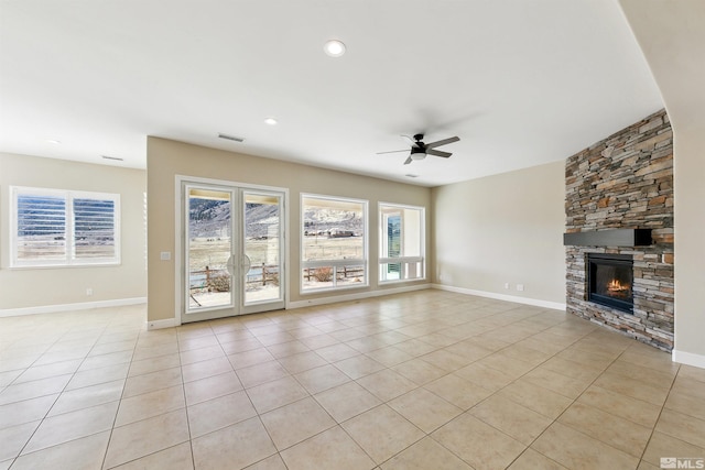 unfurnished living room with ceiling fan, light tile patterned floors, a fireplace, and french doors