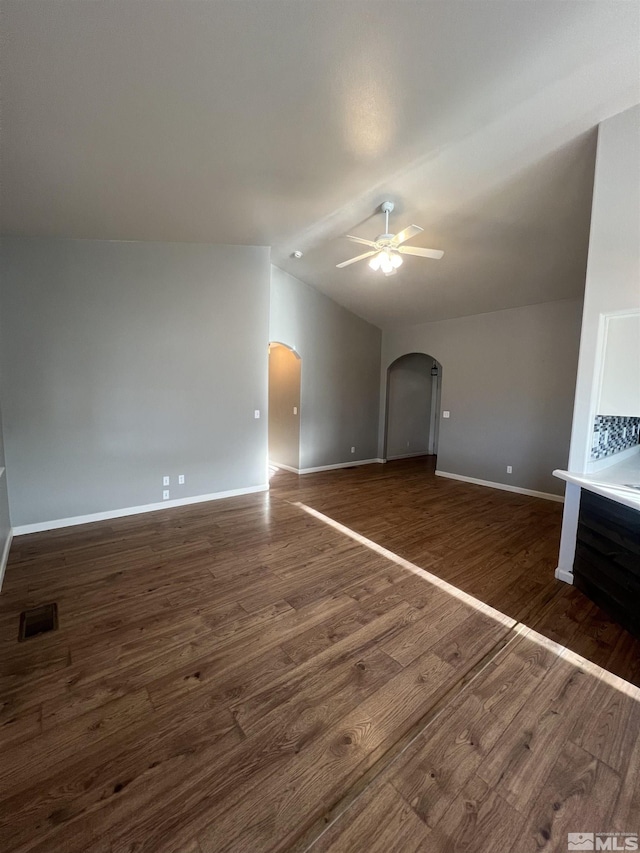 unfurnished living room with ceiling fan, lofted ceiling, and dark hardwood / wood-style floors