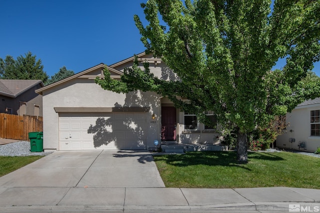 view of front of home with a garage and a front lawn