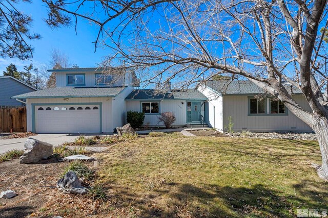 view of front of house featuring a garage and a front yard