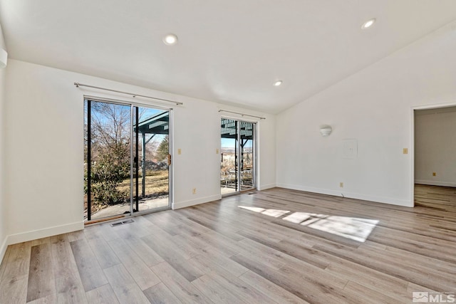 unfurnished room with light hardwood / wood-style flooring and vaulted ceiling