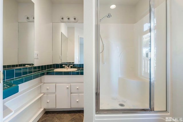 bathroom featuring vanity, an enclosed shower, and tile patterned flooring