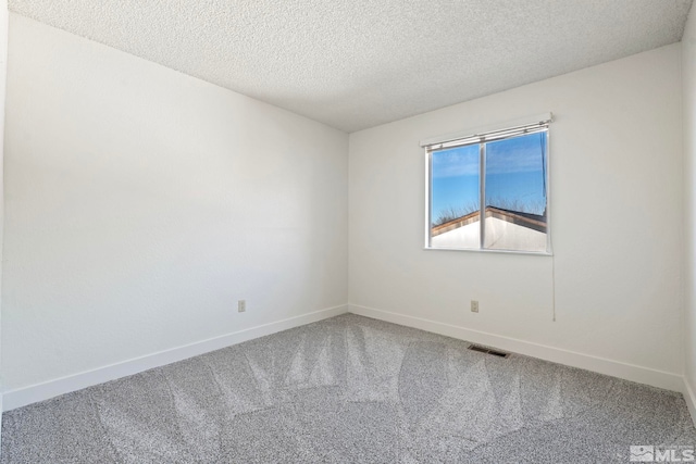 unfurnished room featuring a textured ceiling and carpet flooring