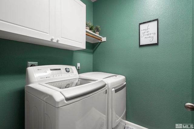 laundry room featuring cabinets and washing machine and dryer