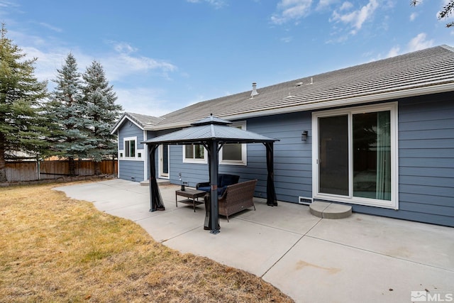 back of house featuring an outdoor living space, a gazebo, a lawn, and a patio