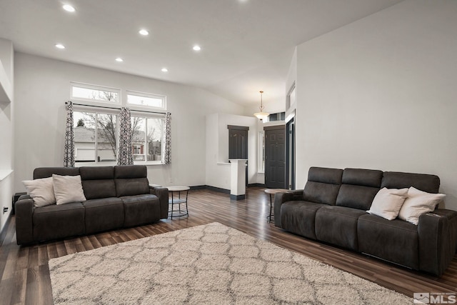 living room with lofted ceiling and dark hardwood / wood-style flooring