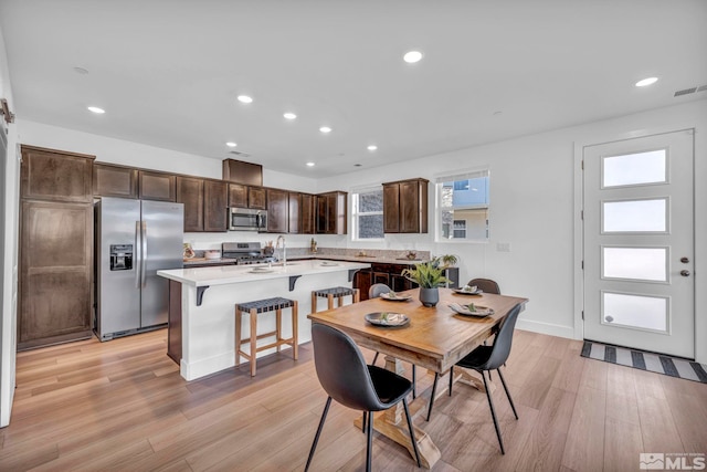 dining room with baseboards, recessed lighting, visible vents, and light wood-style floors