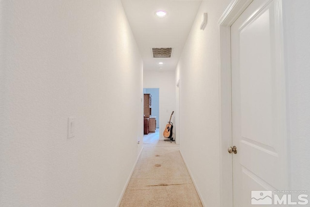 hall featuring light colored carpet