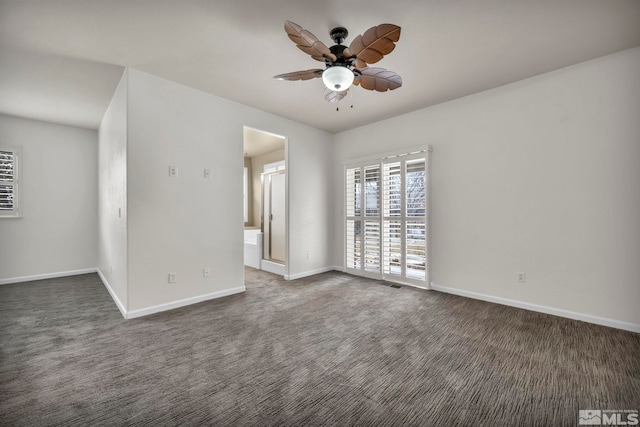 empty room with dark carpet and ceiling fan