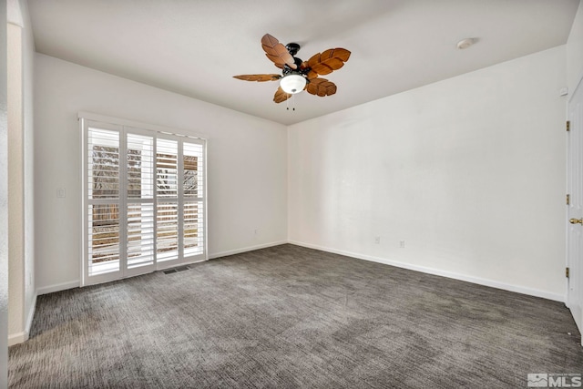 carpeted spare room featuring ceiling fan