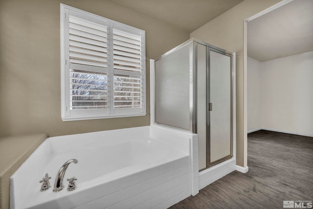 bathroom featuring hardwood / wood-style floors and independent shower and bath