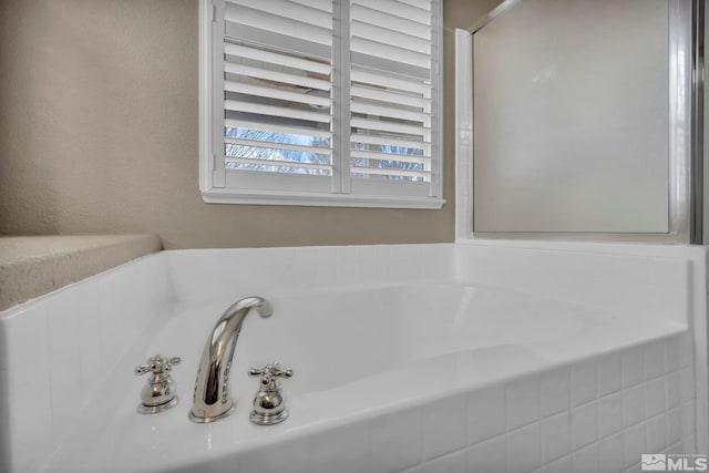 bathroom with tiled bath