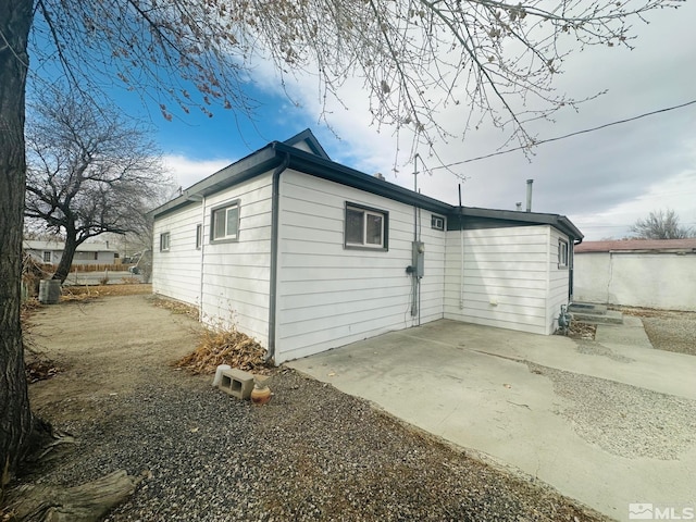 view of side of home featuring a patio area