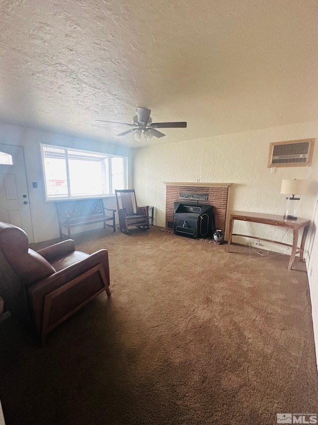 carpeted living room with ceiling fan, a textured ceiling, and a wood stove