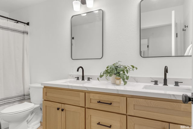 bathroom featuring walk in shower, vanity, and toilet