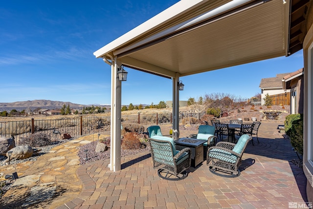 view of patio featuring a mountain view and a fire pit