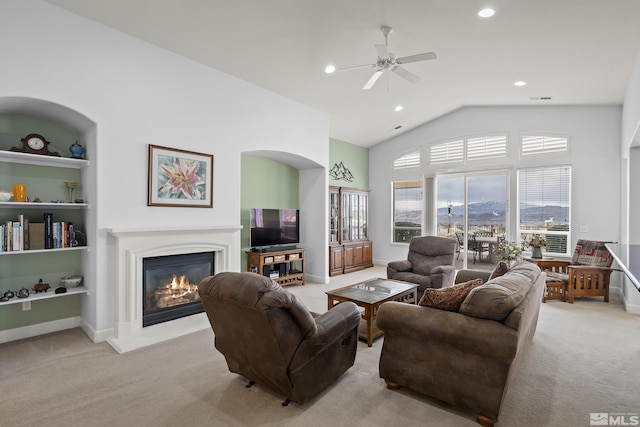 carpeted living room featuring vaulted ceiling and ceiling fan