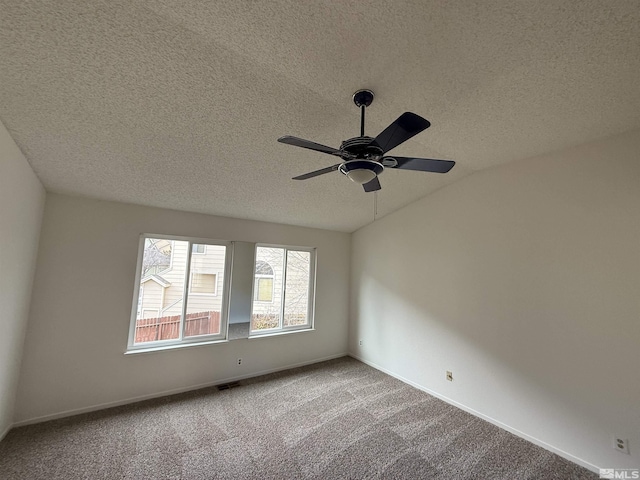 unfurnished room with ceiling fan, carpet, and a textured ceiling