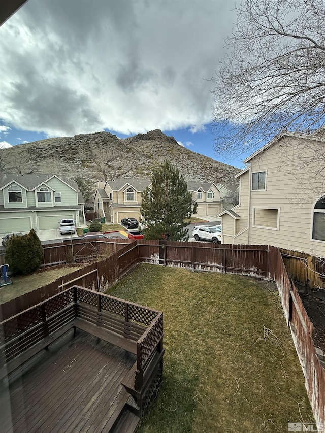 view of yard featuring a deck with mountain view