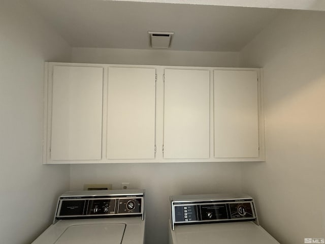 washroom with cabinets and washer / dryer