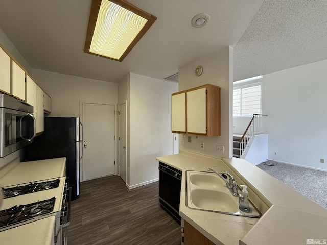 kitchen featuring sink, dark wood-type flooring, black dishwasher, range with gas stovetop, and a textured ceiling