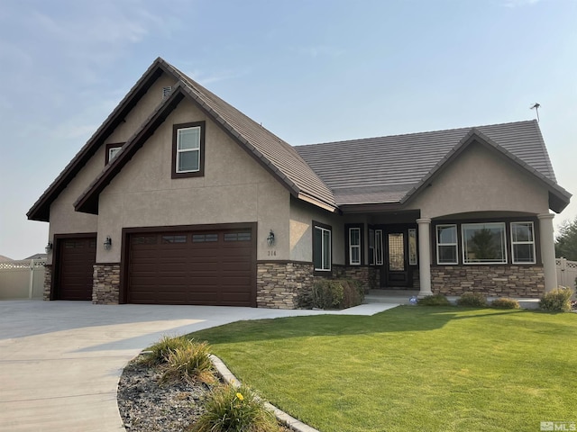 view of front of home featuring a garage and a front lawn