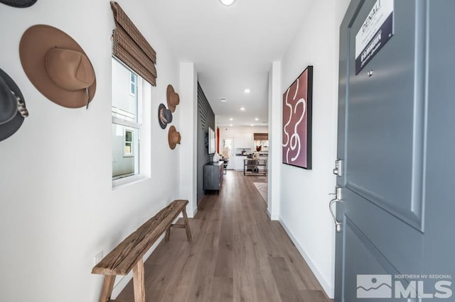 corridor with hardwood / wood-style floors