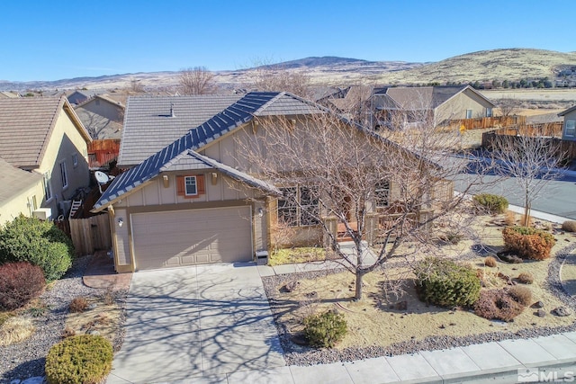 ranch-style home featuring a garage and a mountain view