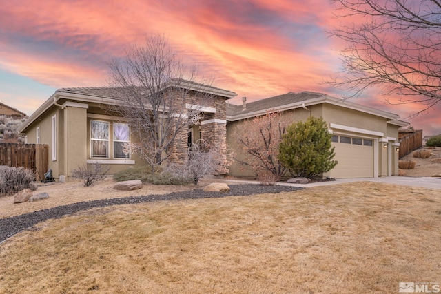 view of front of home featuring a garage and a yard