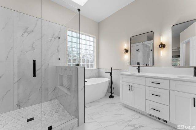 bathroom featuring vanity, independent shower and bath, and tile walls