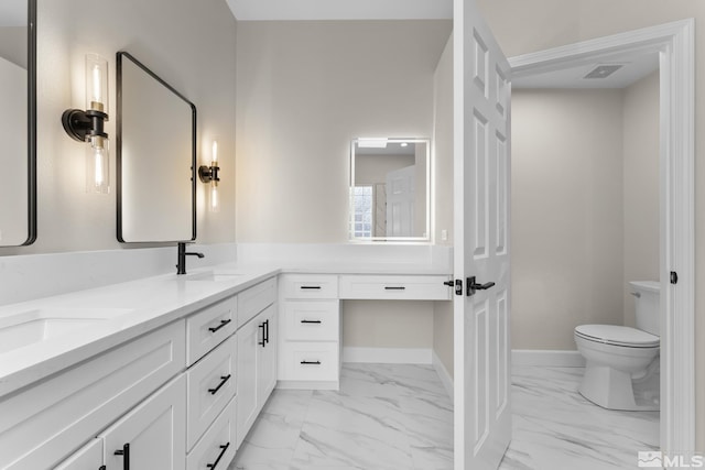 bathroom featuring vanity and toilet