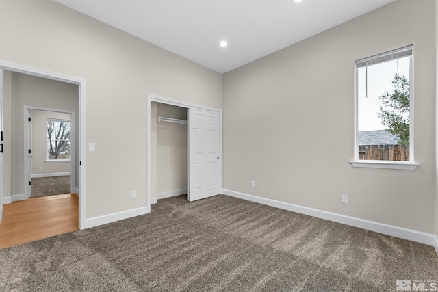 unfurnished bedroom featuring a closet and carpet