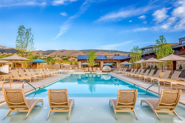 view of pool featuring a patio and a mountain view