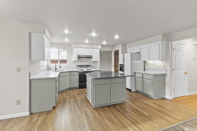 kitchen with a kitchen island, sink, gray cabinetry, stove, and white fridge with ice dispenser